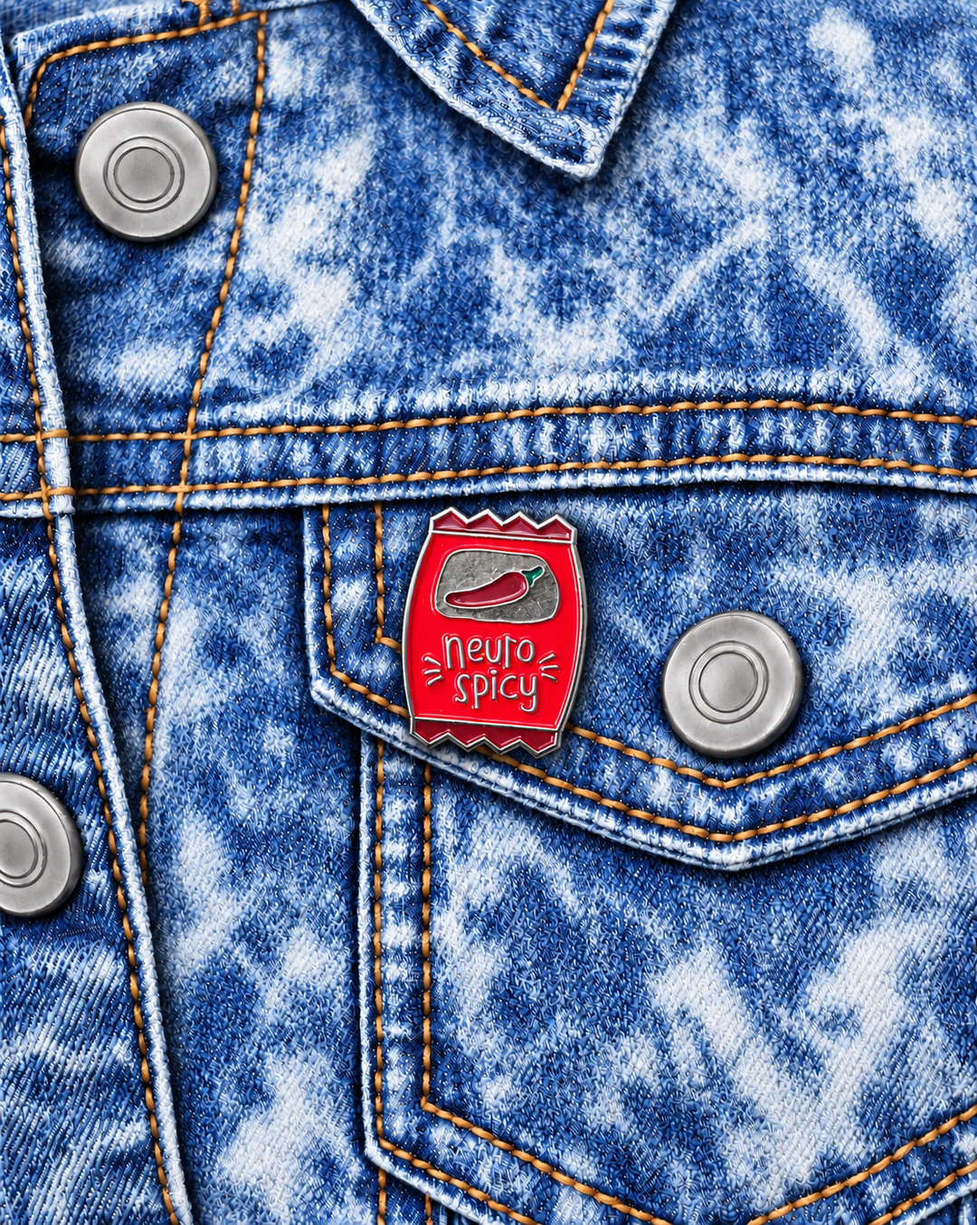 Neuro Spicy Chip Bag Pin displayed on an acid-wash denim jacket beside a metal button