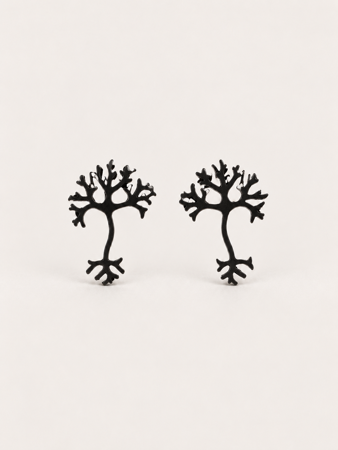 Black stainless steel Neuron Stud Earrings shown on a warm neutral background