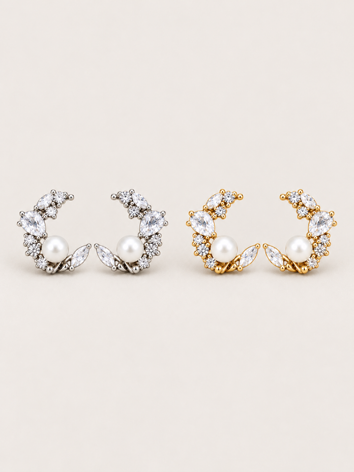 Pearl Crystal Crescent Earrings in silver and gold shown on a warm neutral background