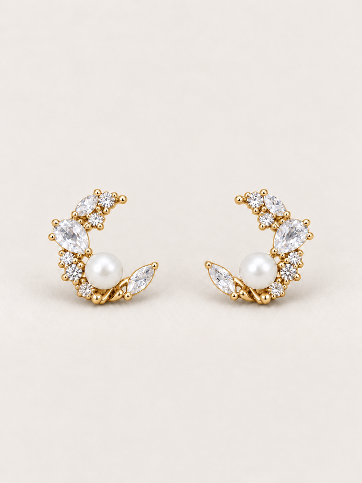 Gold Pearl Crystal Crescent Earrings shown on a warm neutral background