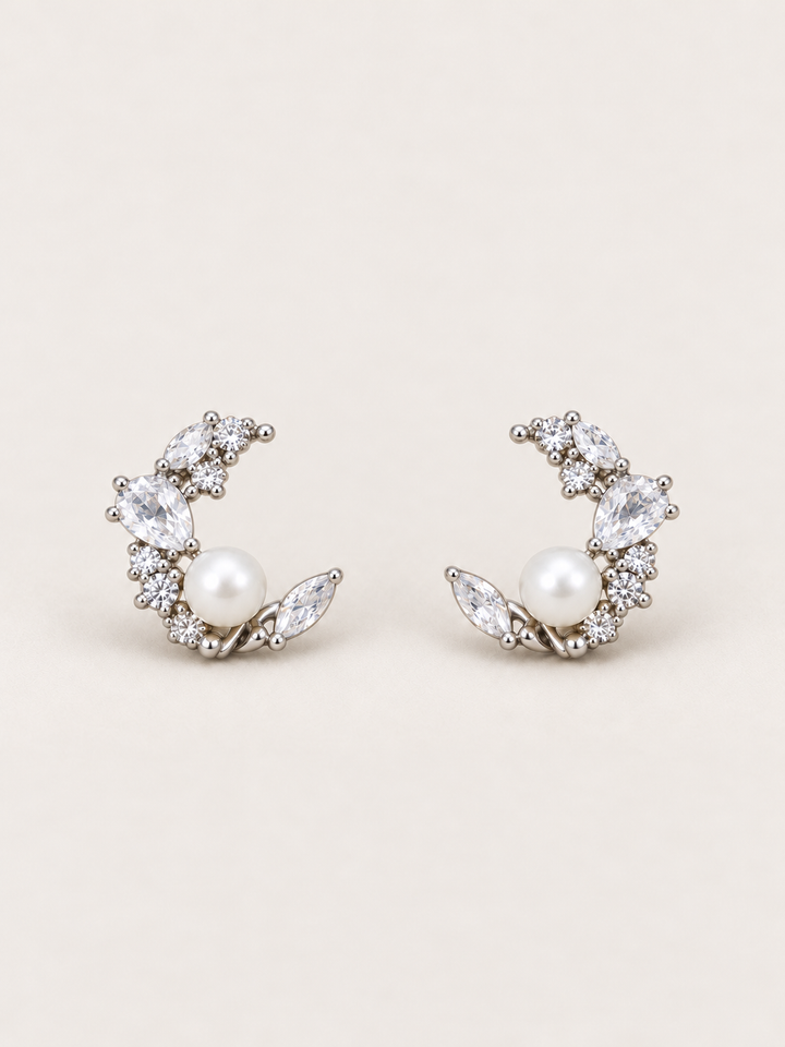 Silver Pearl Crystal Crescent Earrings shown on a warm neutral background