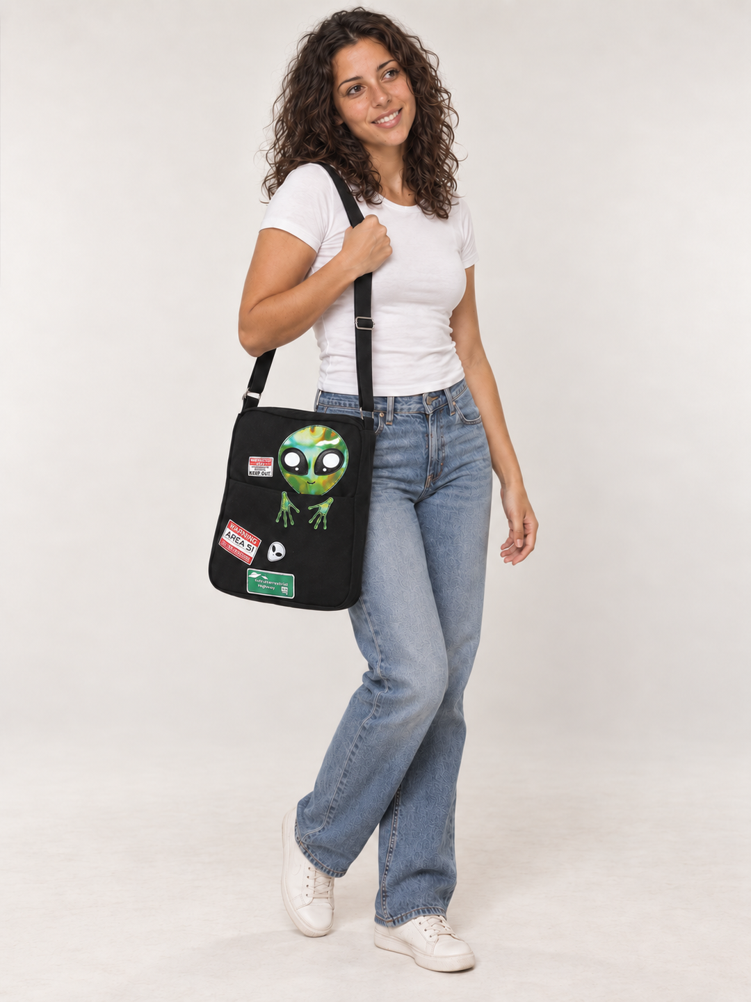 Model wearing the Peeking Alien Canvas Bag over her shoulder