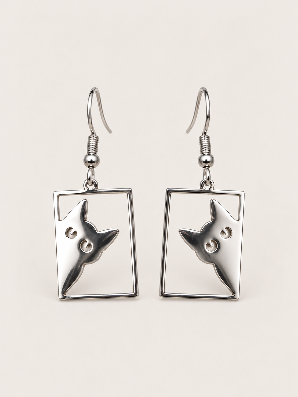 Silver Peeking Cat Rectangle Drop Earrings shown on a warm neutral background