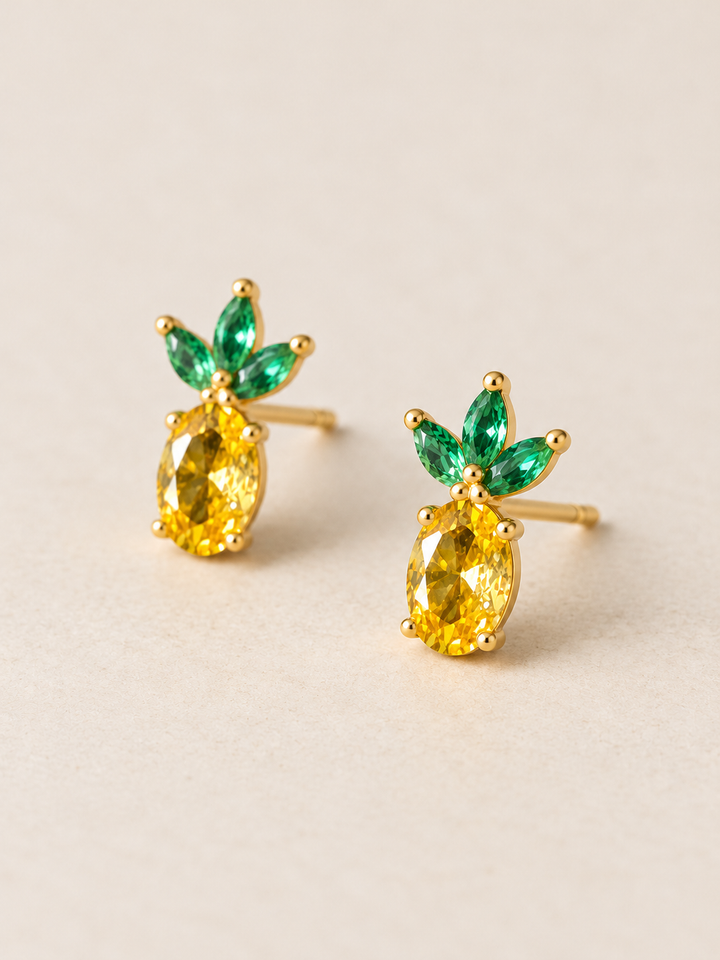 Pineapple Stud Earrings shown angled on a warm neutral background