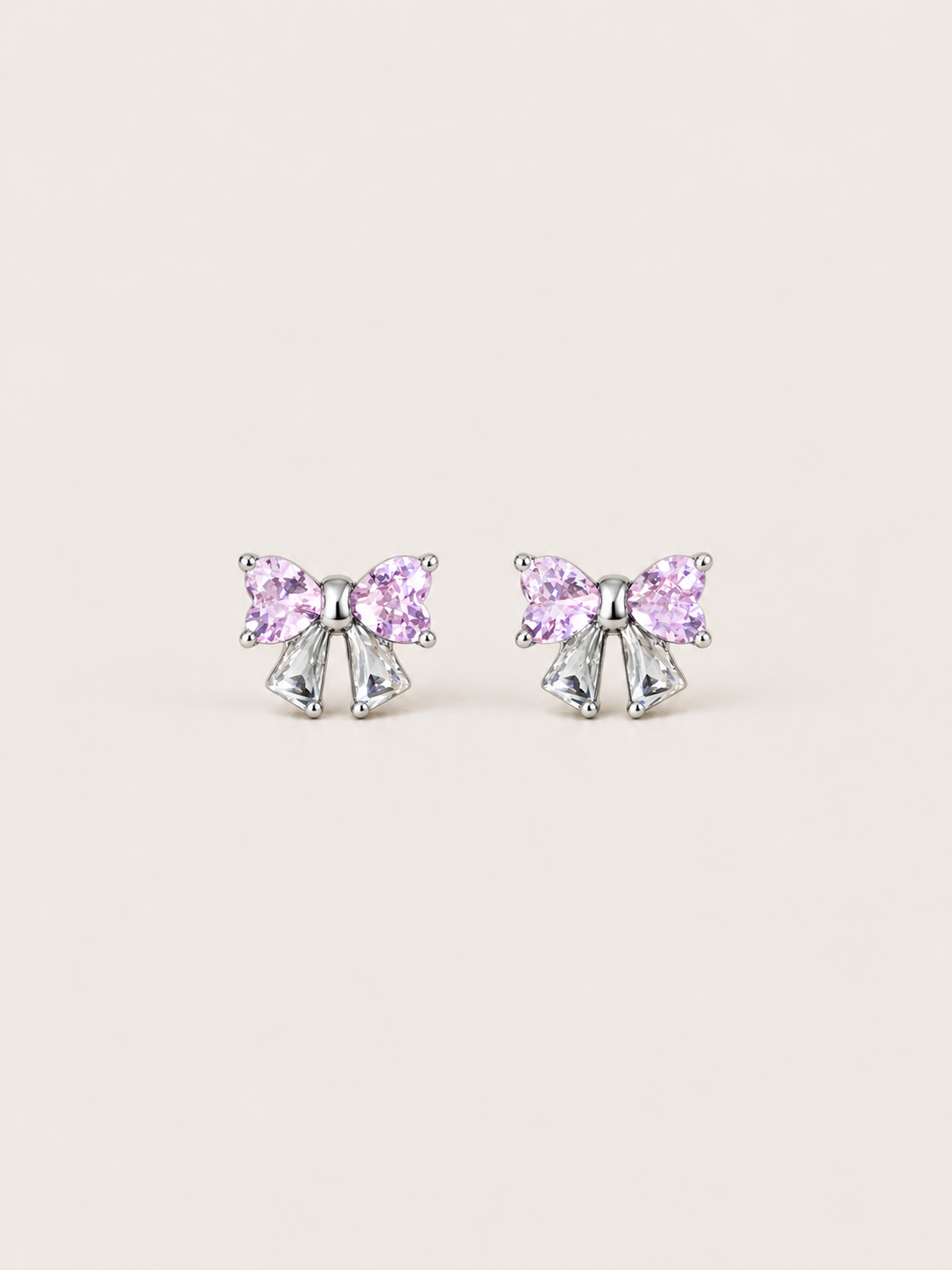 Pink Crystal Bow Stud Earrings shown on a warm neutral background