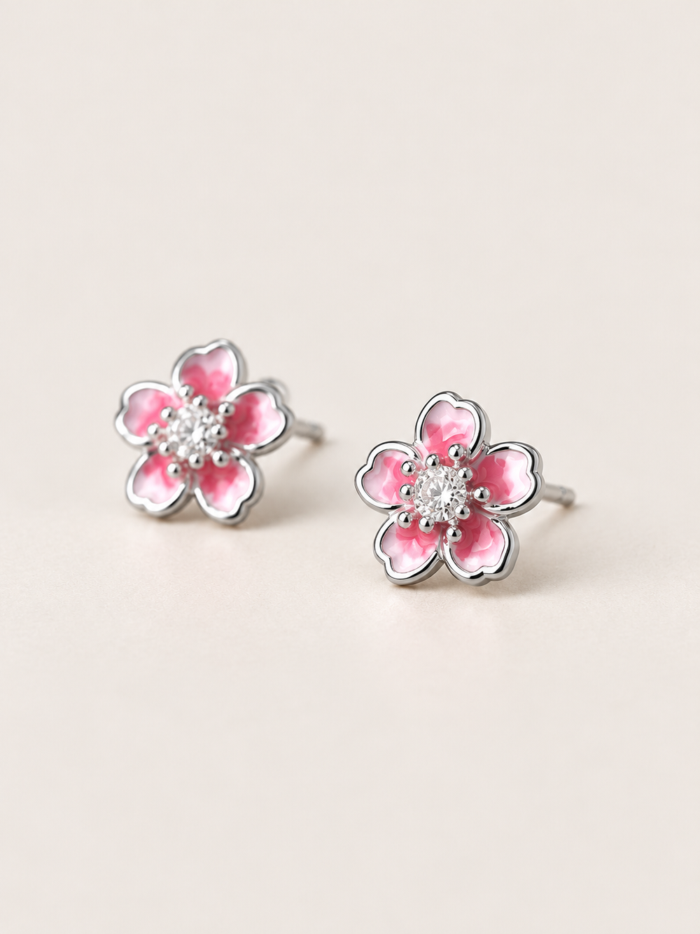 Pink Flower Stud Earrings shown angled on a warm neutral background