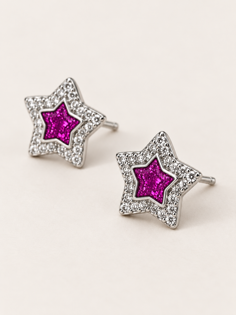 Pink Star Stud Earrings shown angled on a warm neutral background