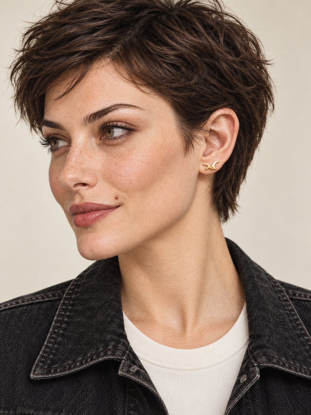 Gold Pterodactyl Stud Earring worn on the viewer-right ear