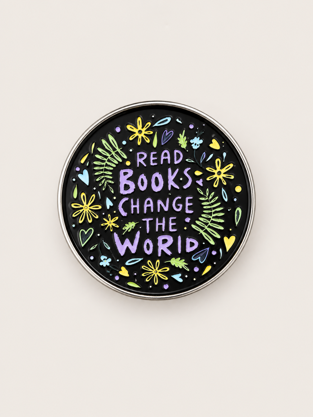 Read Books Change the World Floral Pin shown on a warm neutral background