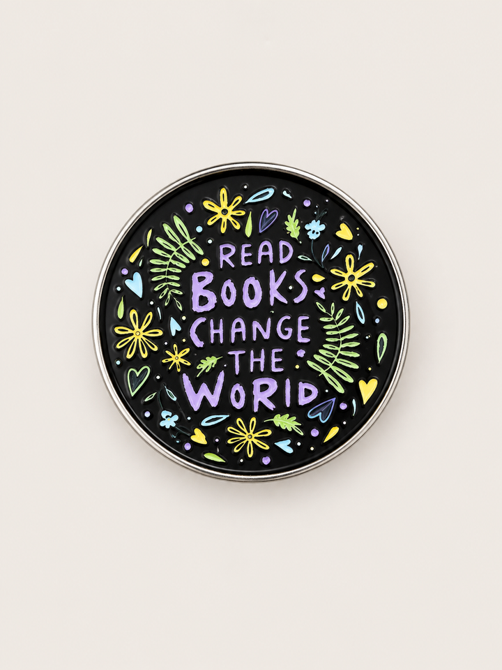 Read Books Change the World Floral Pin shown on a warm neutral background