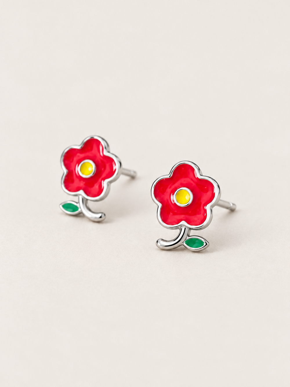 Red Flower Stud Earrings shown angled on a warm neutral background