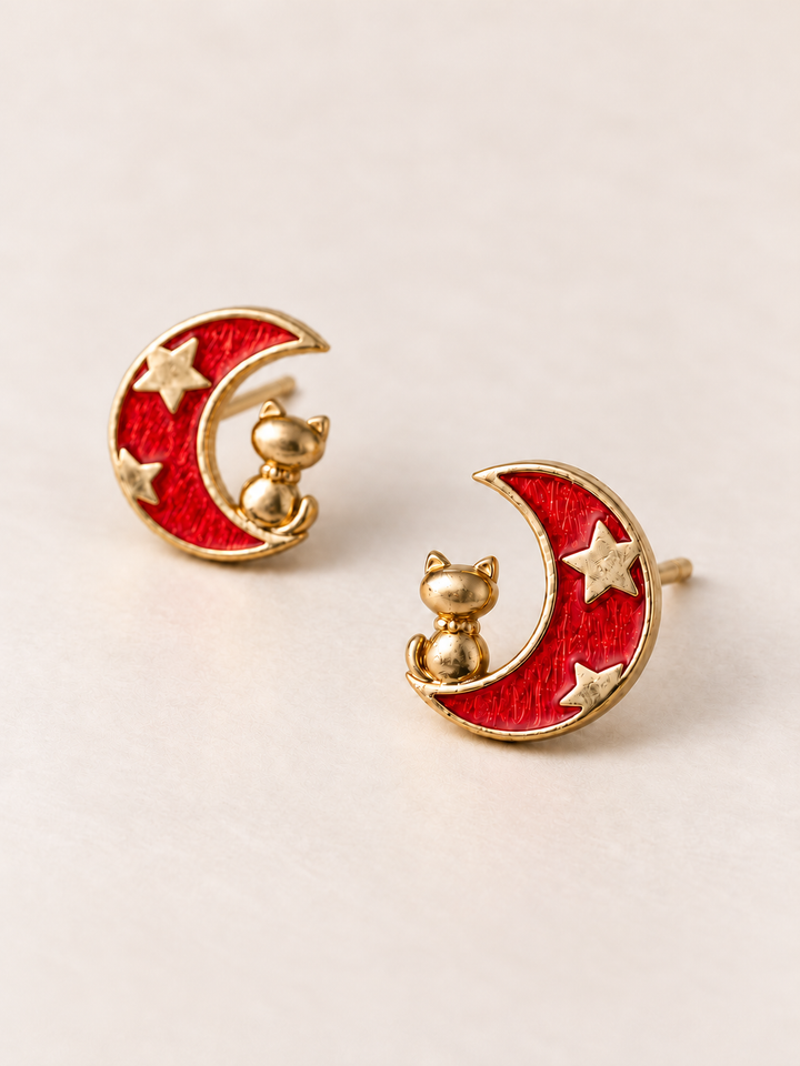 Red Moon and Cat Stud Earrings shown angled on a warm neutral background