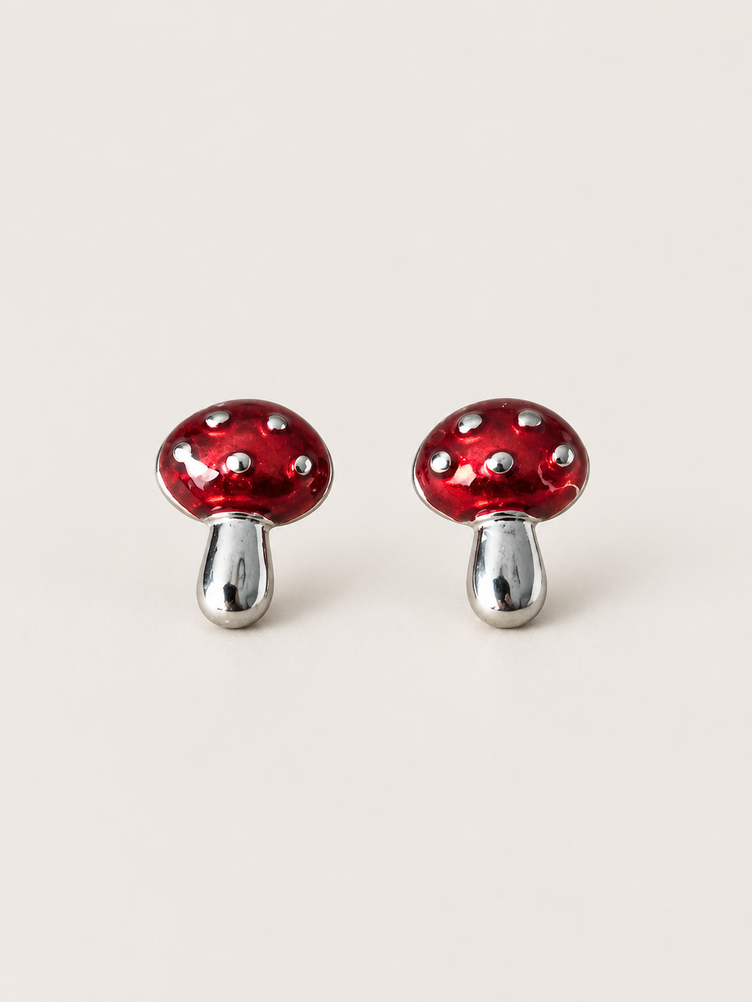 Red Mushroom Stud Earrings shown on a warm neutral background