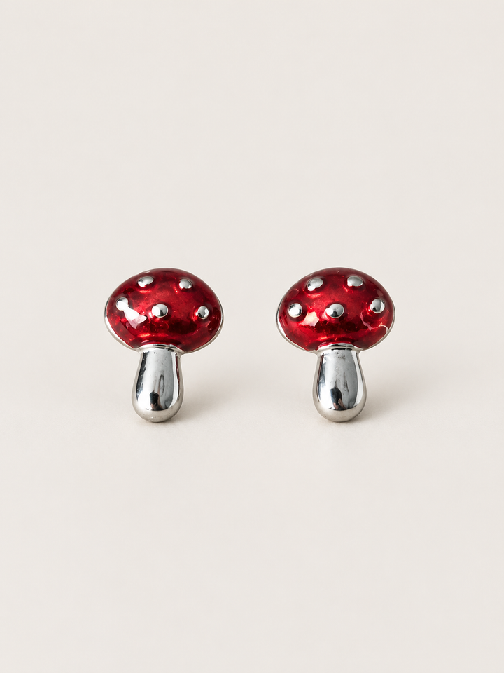 Red Mushroom Stud Earrings shown on a warm neutral background