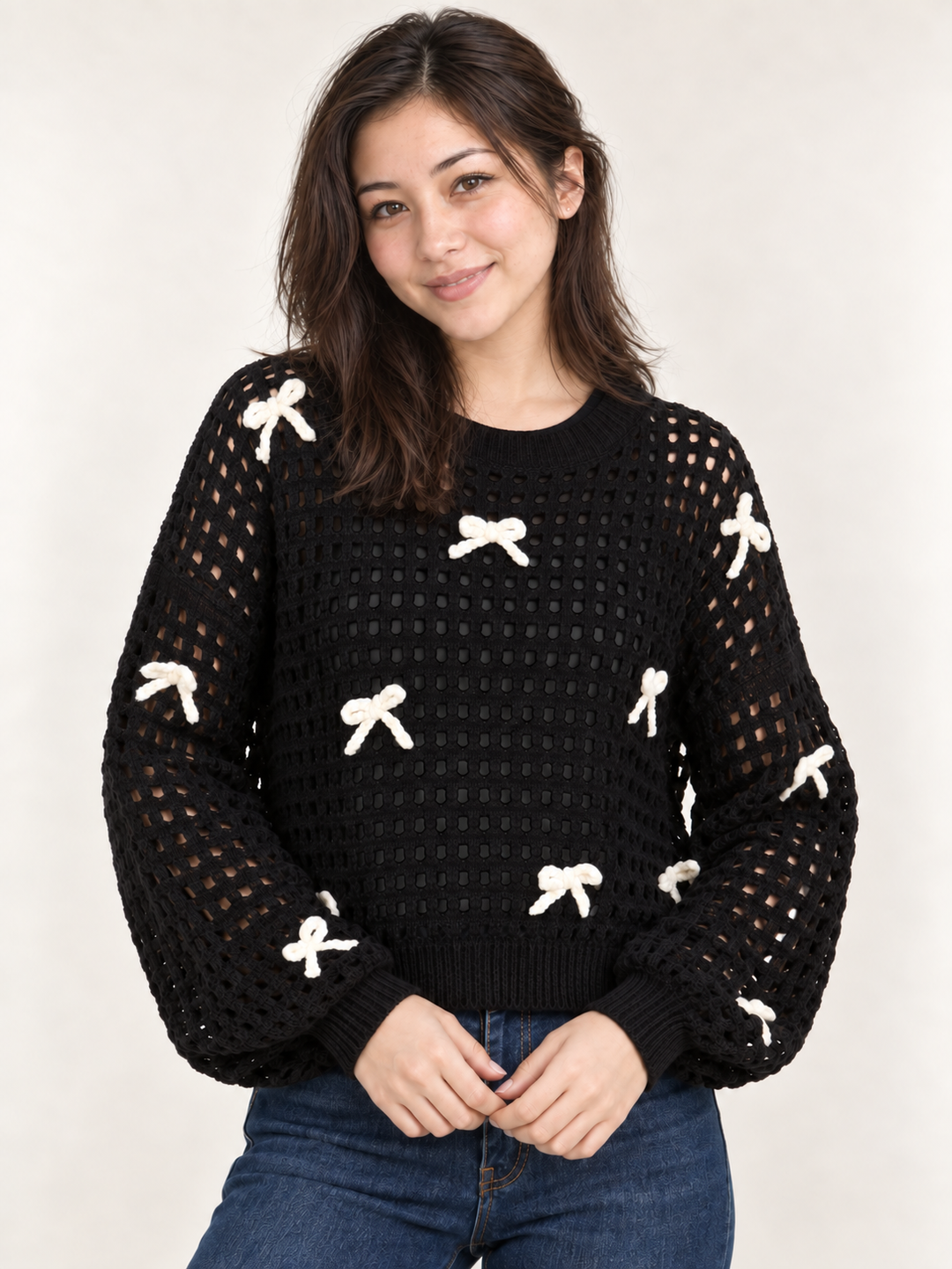 Model wearing black ribbon open-knit sweater, front view