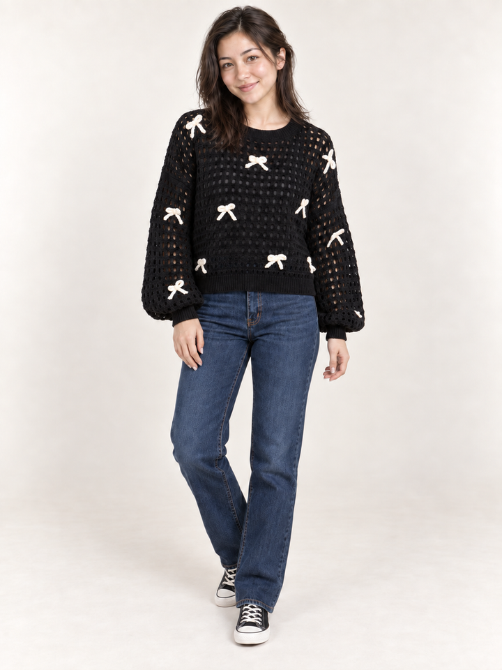 Model wearing black ribbon open-knit sweater, full body view
