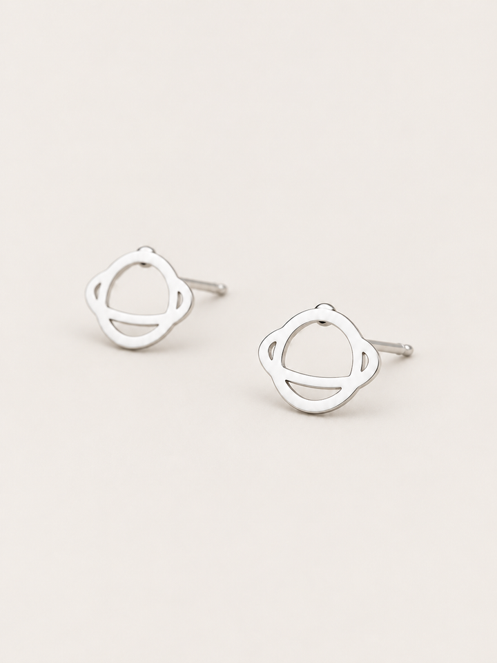 Ringed Planet Stud Earrings silver angled view on a warm neutral background