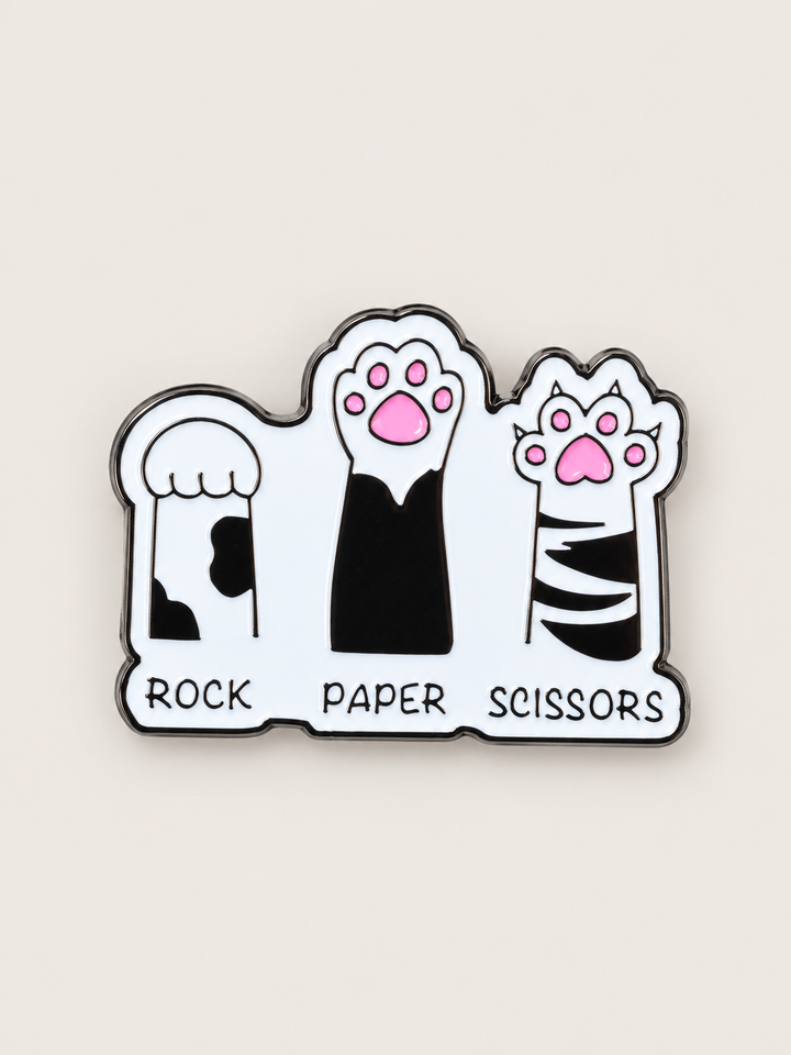 Rock Paper Scissors Cat Paws Pin shown on a warm neutral background