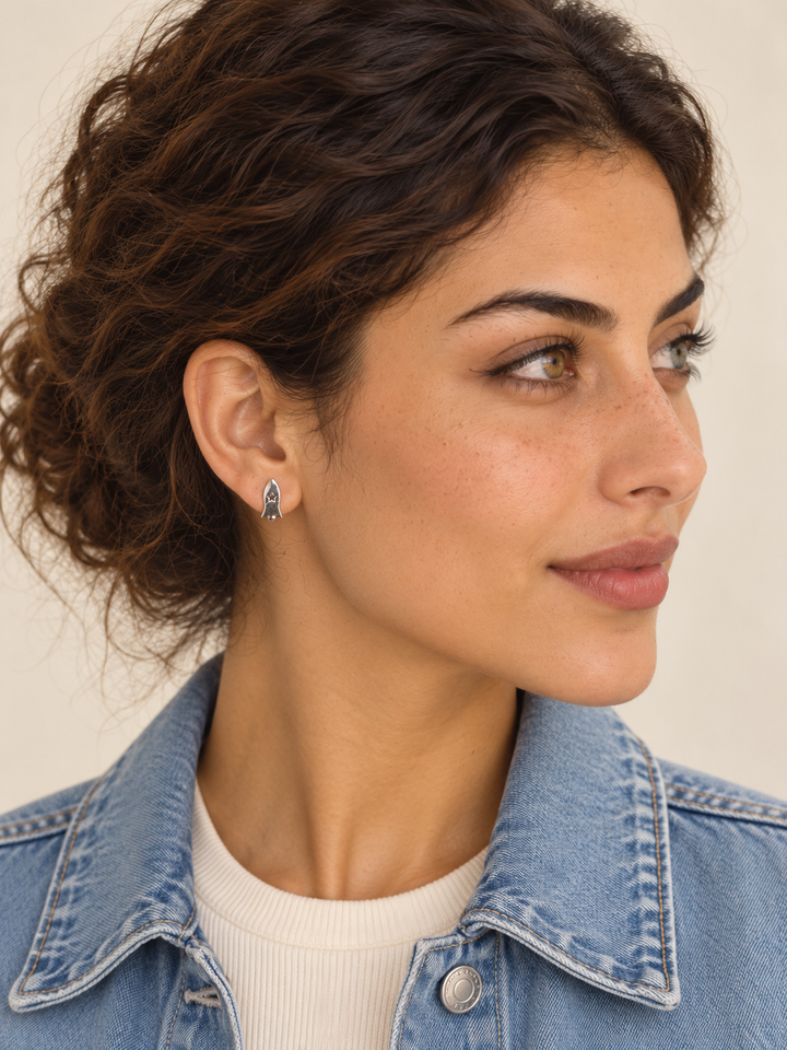 Model wearing the silver rocket stud on the viewer-left ear