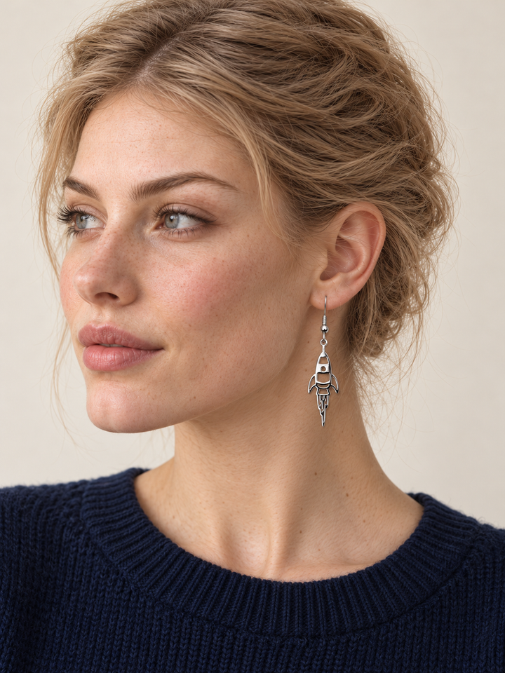 Silver Rocket Drop Earrings worn by a model in a dark blue sweater