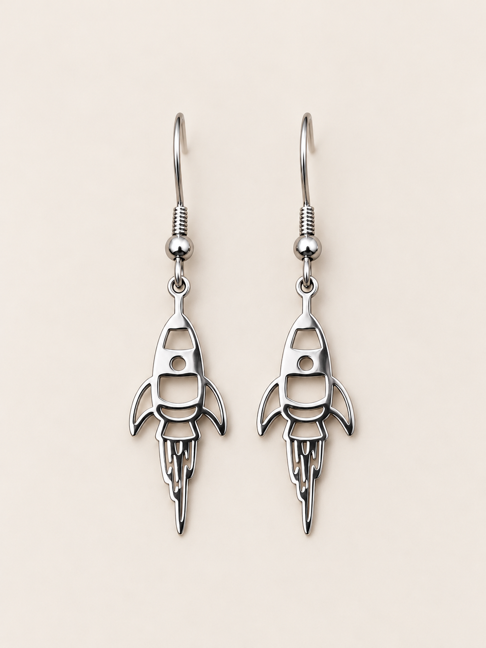 Silver Rocket Drop Earrings on a warm neutral background