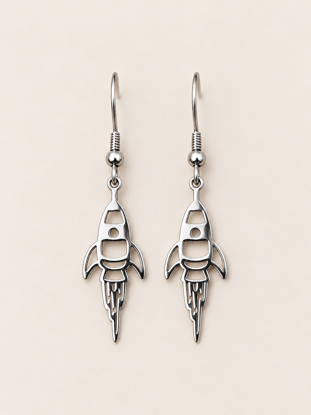Silver Rocket Drop Earrings on a warm neutral background