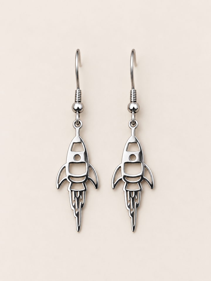 Silver Rocket Drop Earrings on a warm neutral background