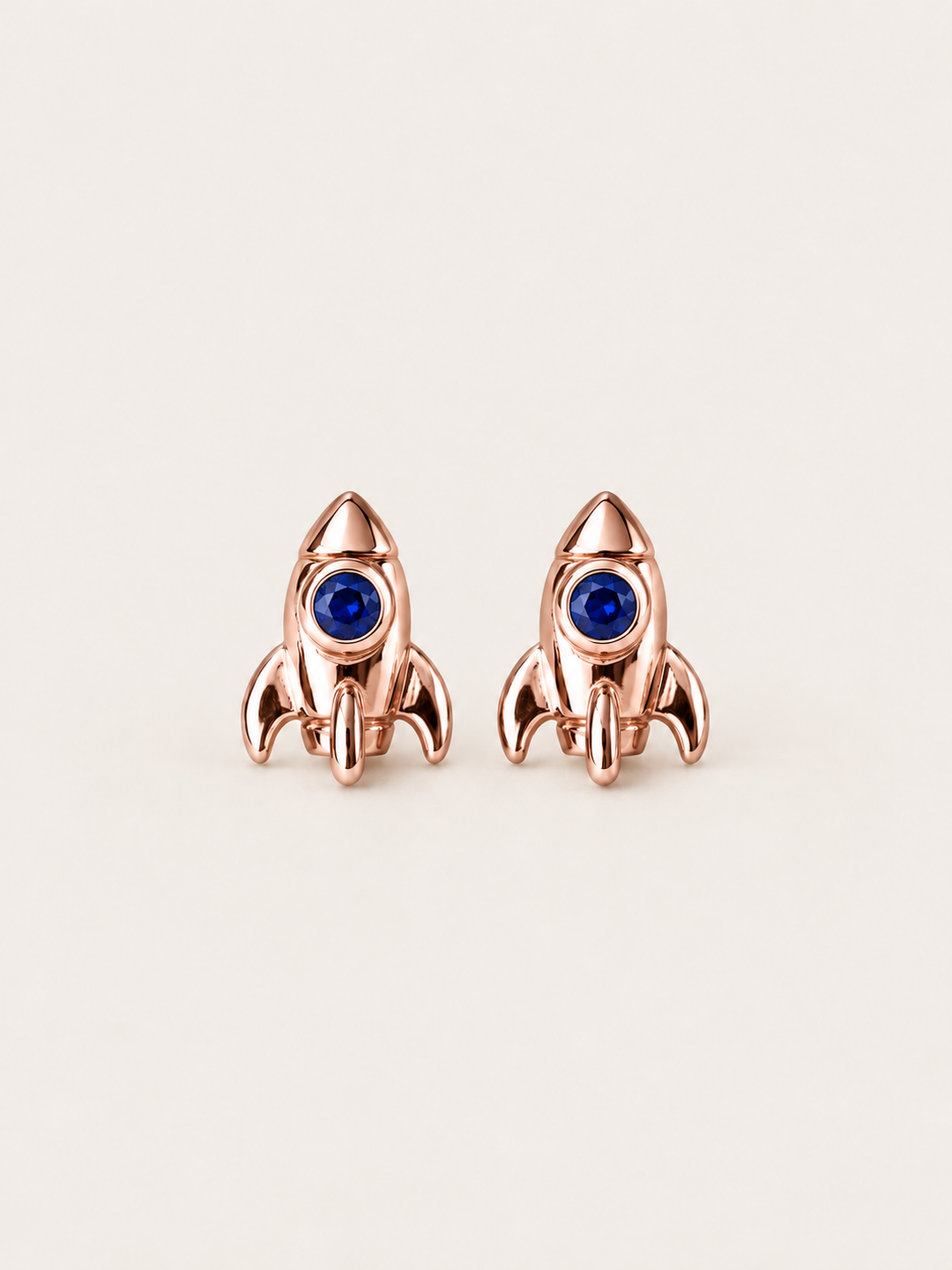 Rocket Stud Earrings in Rose Gold shown on a warm neutral background