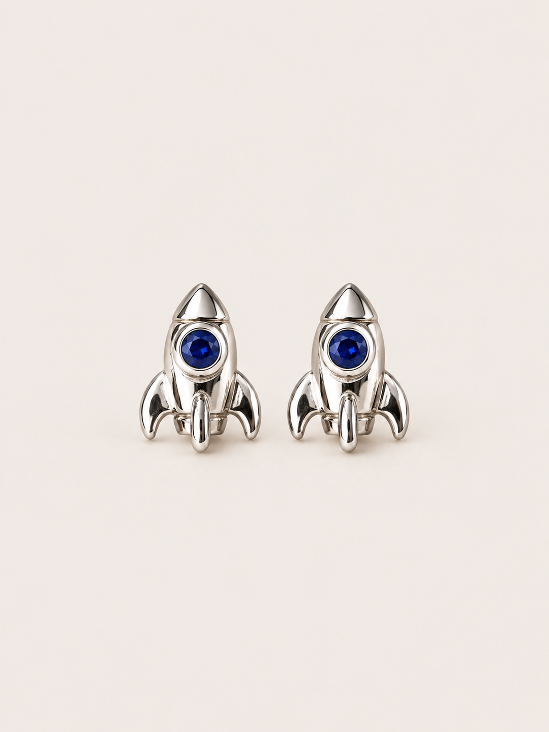 Rocket Stud Earrings in Silver shown on a warm neutral background