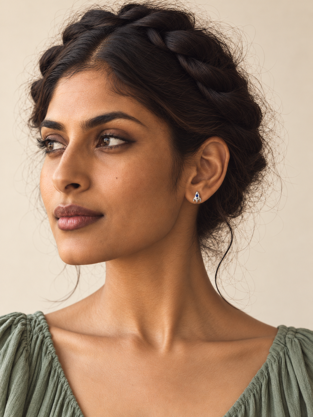 Tiny silver Rocket Stud Earrings worn on a model