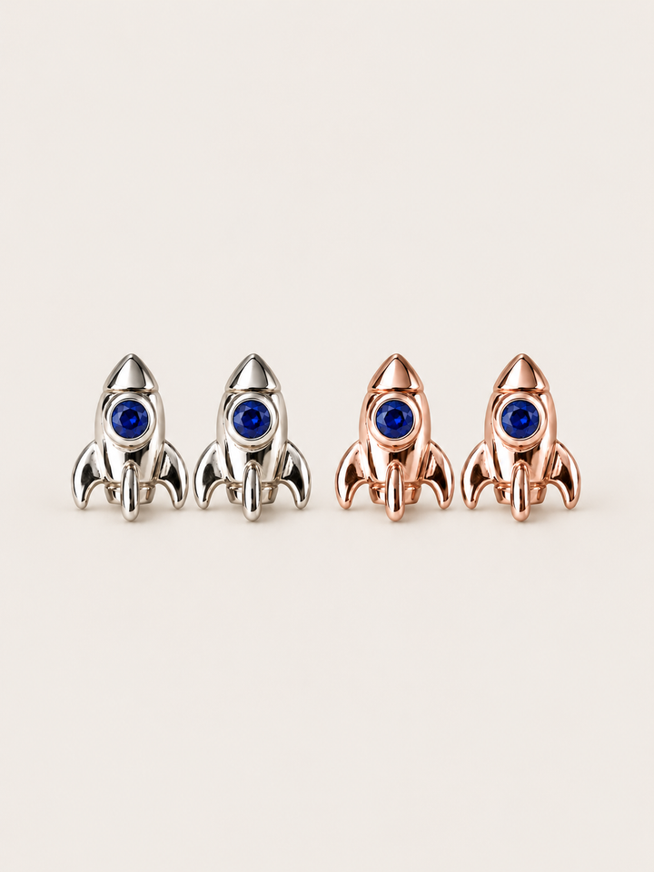 Rocket Stud Earrings in Silver and Rose Gold shown on a warm neutral background