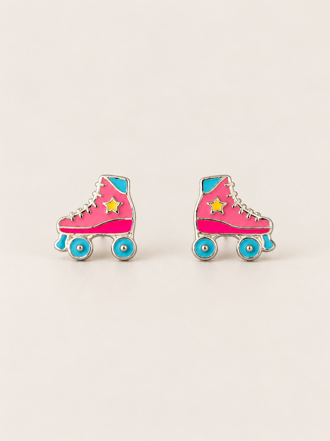 Roller Skate Stud Earrings shown on a warm neutral background