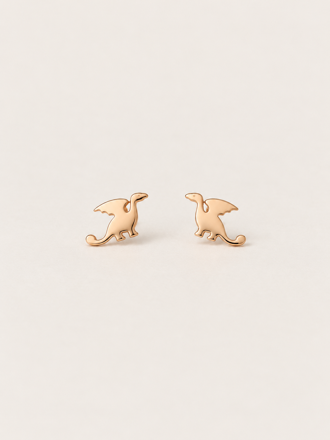 Dragon Stud Earrings shown on a warm neutral background