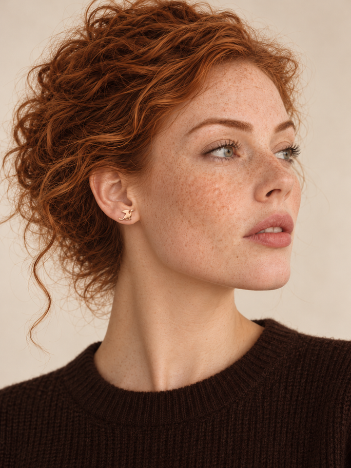 Rose gold Dragon Stud Earrings worn on the viewer-left ear