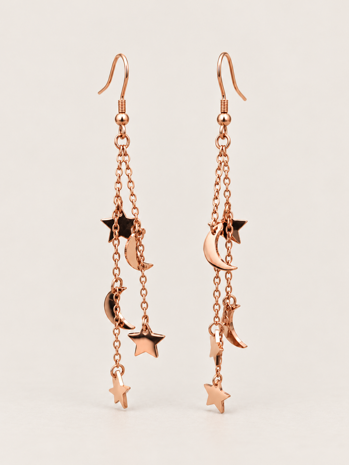 Rose Gold Moon and Star Chain Drop Earrings shown on a warm neutral background