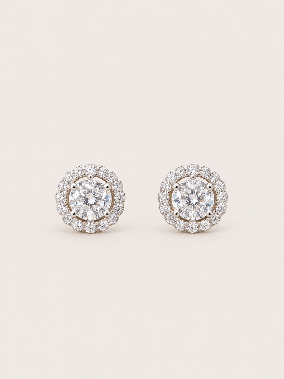 Round Halo Stud Earrings shown on a warm neutral background
