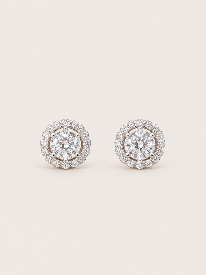 Round Halo Stud Earrings shown on a warm neutral background