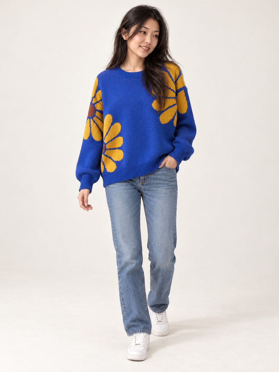 Full-length styling of royal blue daisy knit sweater with jeans