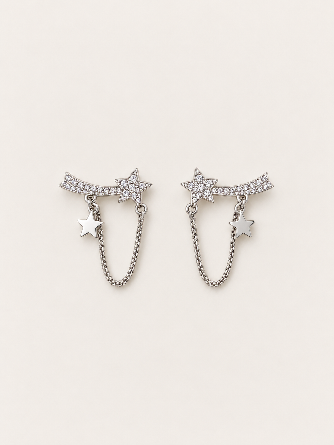 Shooting Star Chain Earrings shown on a warm neutral background