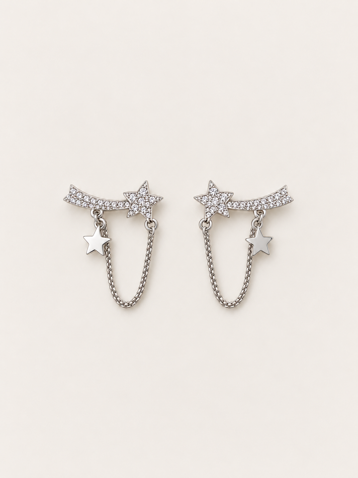 Shooting Star Chain Earrings shown on a warm neutral background