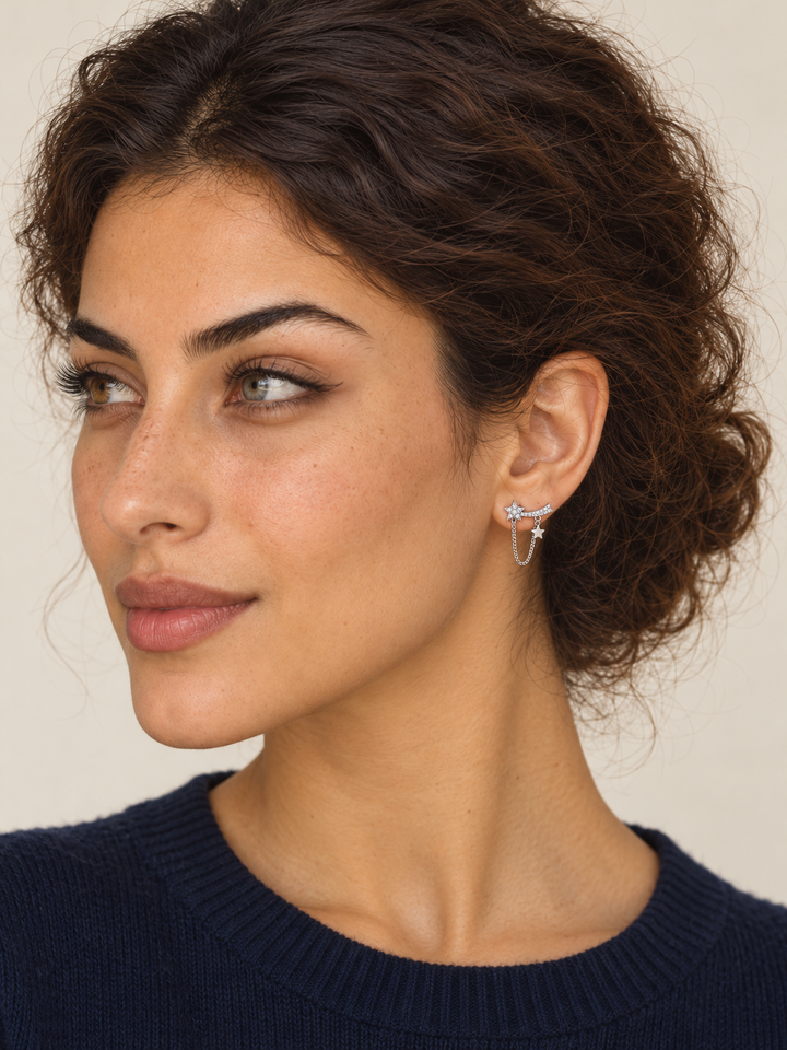 Silver Shooting Star Chain Earrings worn on the viewer-right ear
