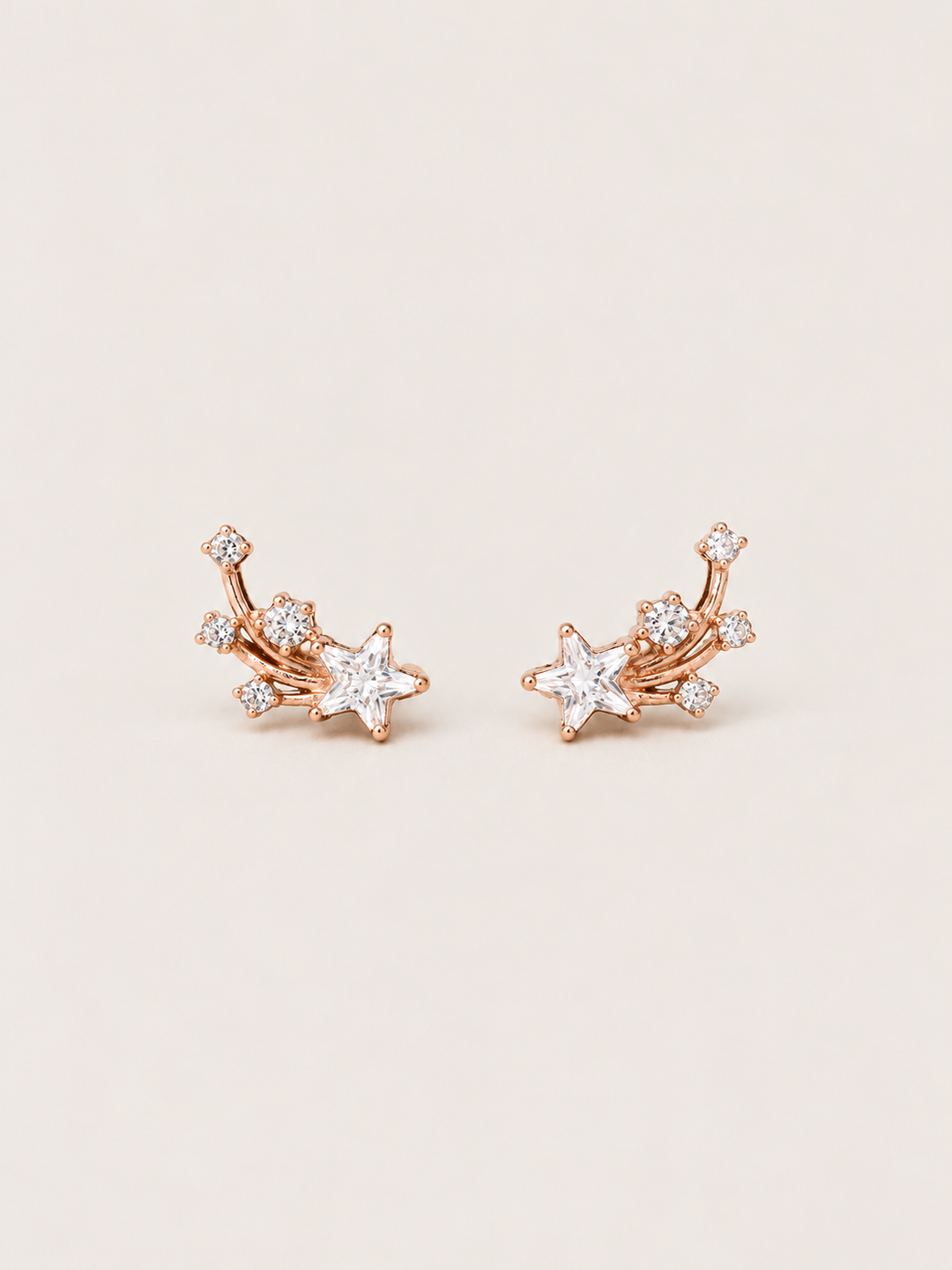Shooting Star Earrings shown on a warm neutral background