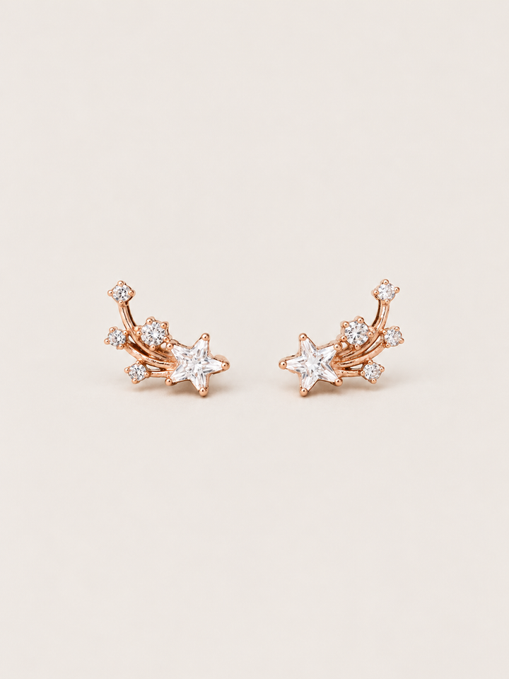 Shooting Star Earrings shown on a warm neutral background