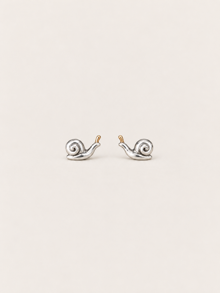 Snail Stud Earrings shown on a warm neutral background