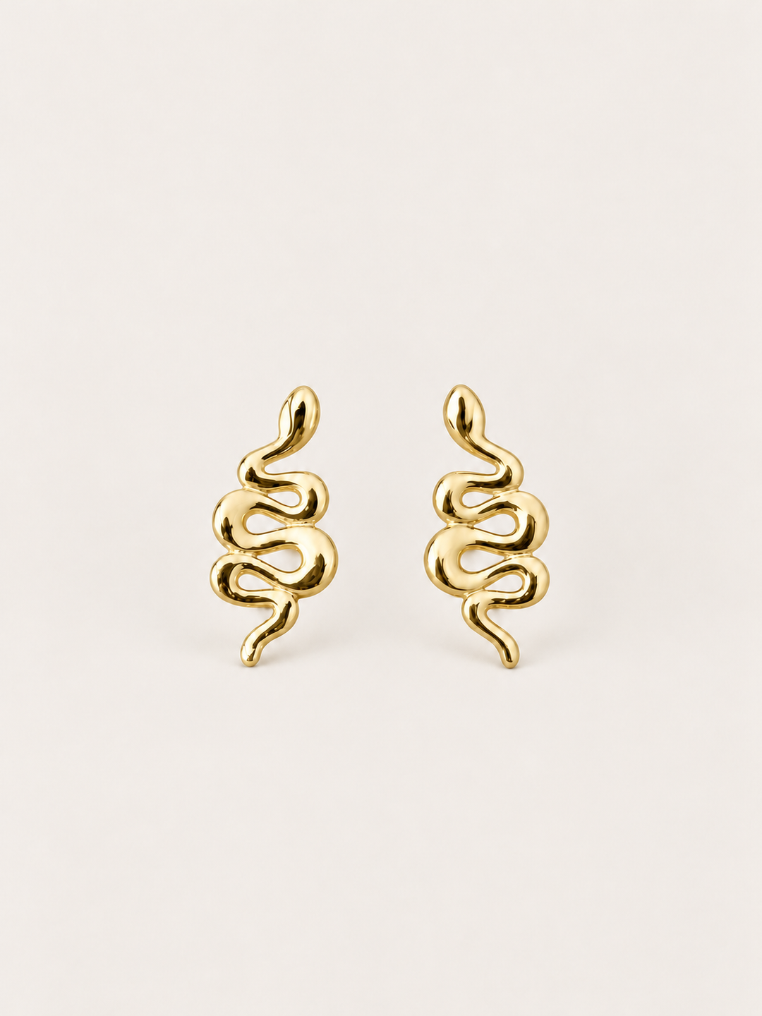 Gold Snake Stud Earrings shown on a warm neutral background