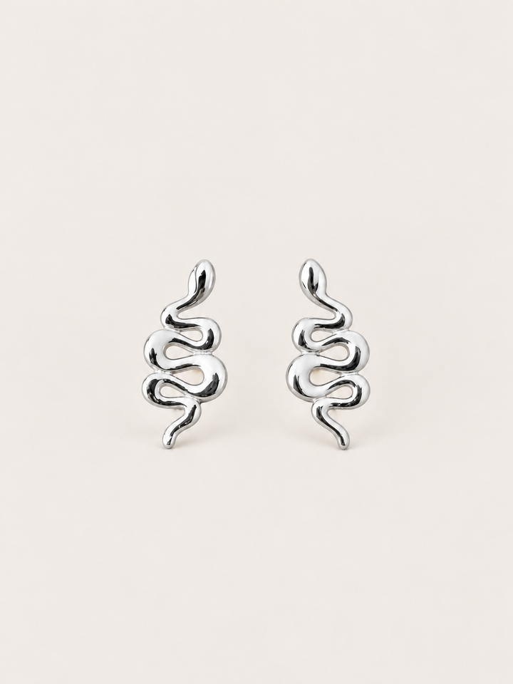 Silver Snake Stud Earrings shown on a warm neutral background