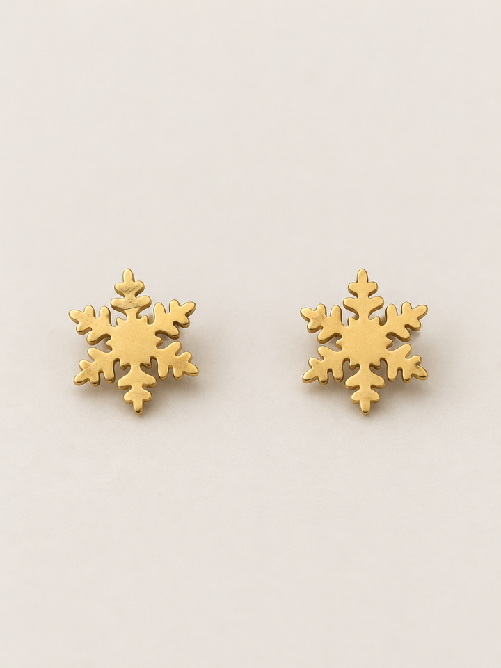 Gold Snowflake Stud Earrings shown on a warm neutral background
