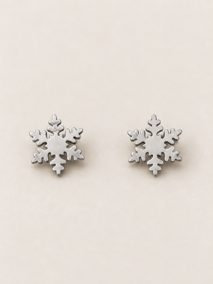 Silver Snowflake Stud Earrings shown on a warm neutral background