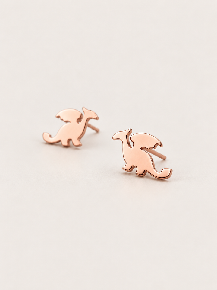 Rose Gold angled Stainless Steel Dragon Stud Earrings on a warm neutral background