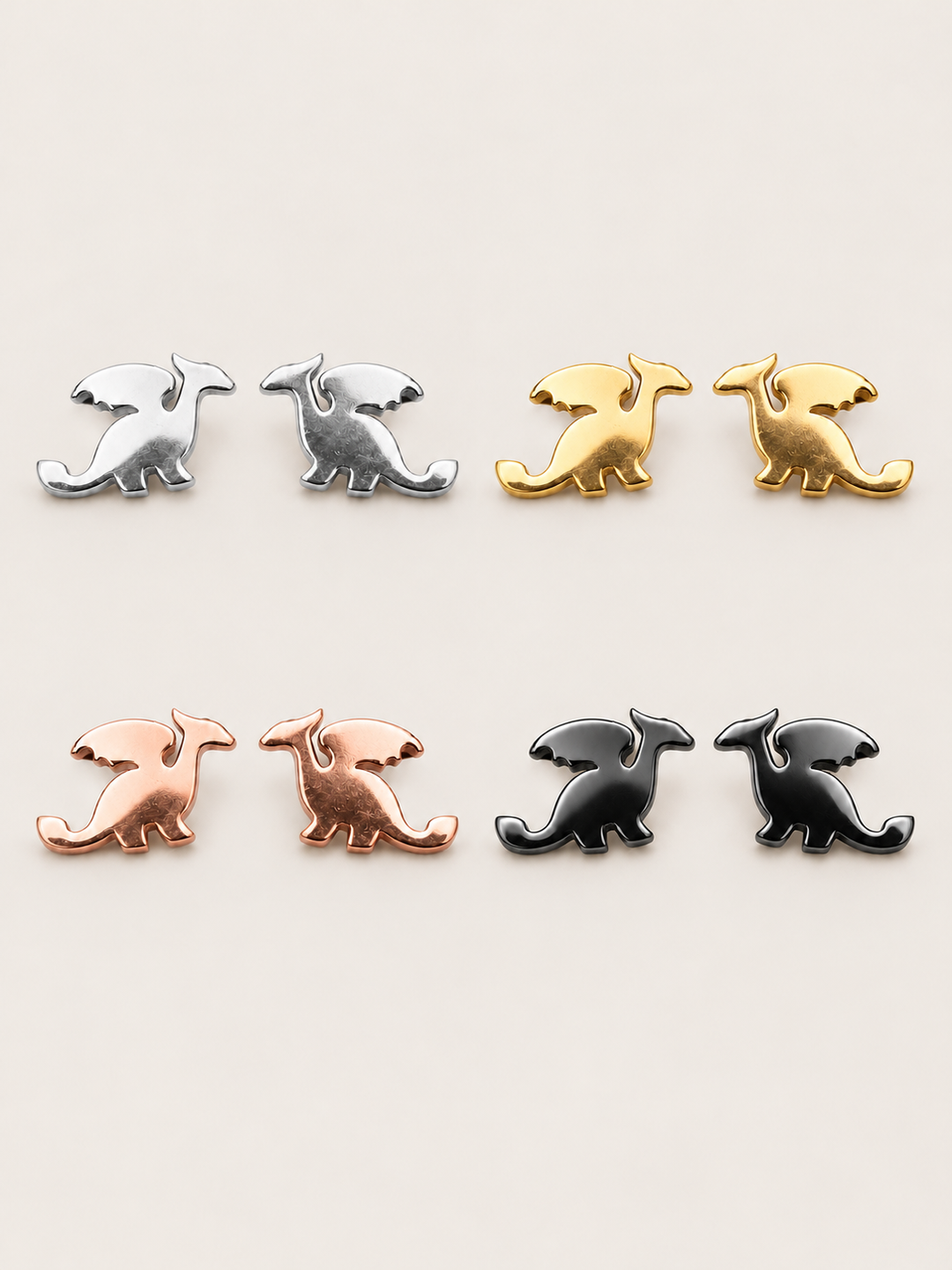 Stainless Steel Dragon Stud Earrings in silver, gold, rose gold and black on a warm neutral background